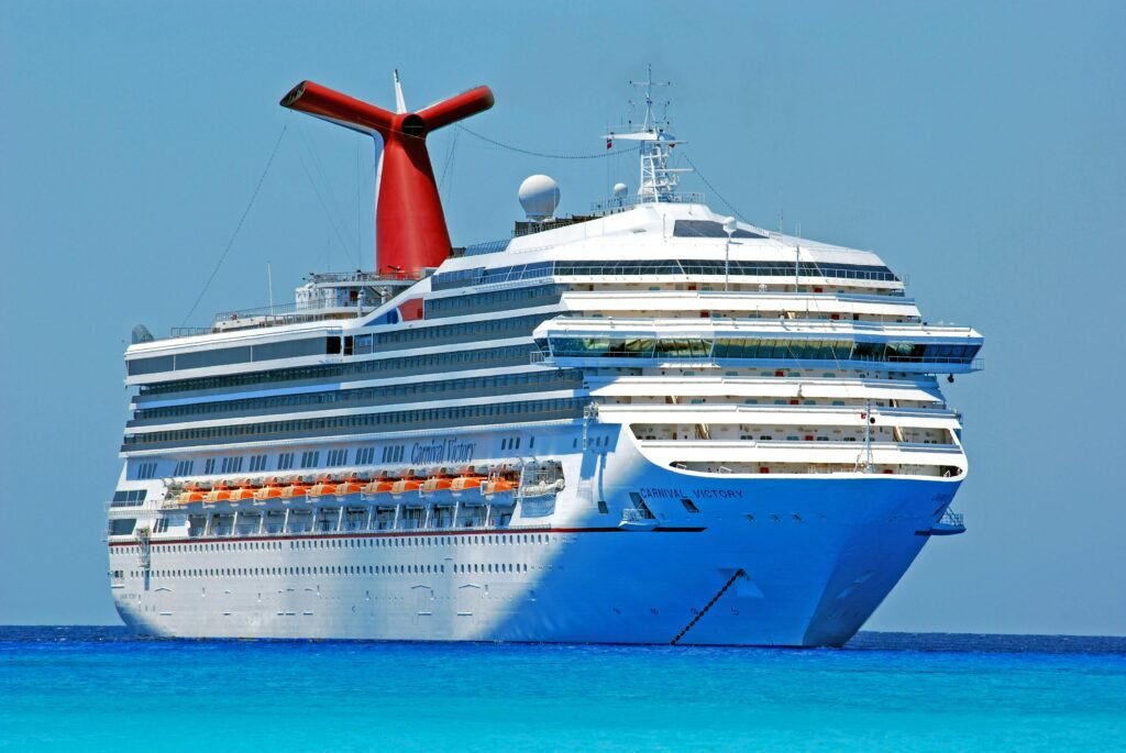 ferry boat ferry ship boat 69122 69122 A large cruise ship gliding through clear blue ocean waters on a sunny day.