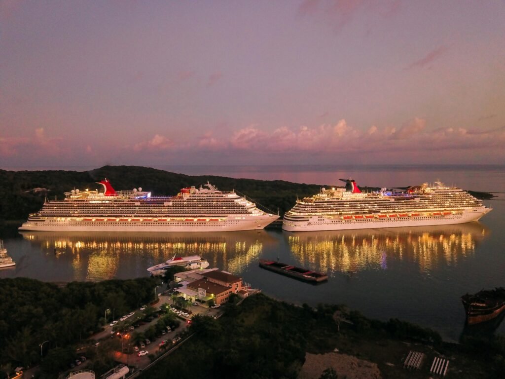 pexels photo 2678418 2678418 Two illuminated cruise ships docked at Coxen Hole, Honduras during twilight.